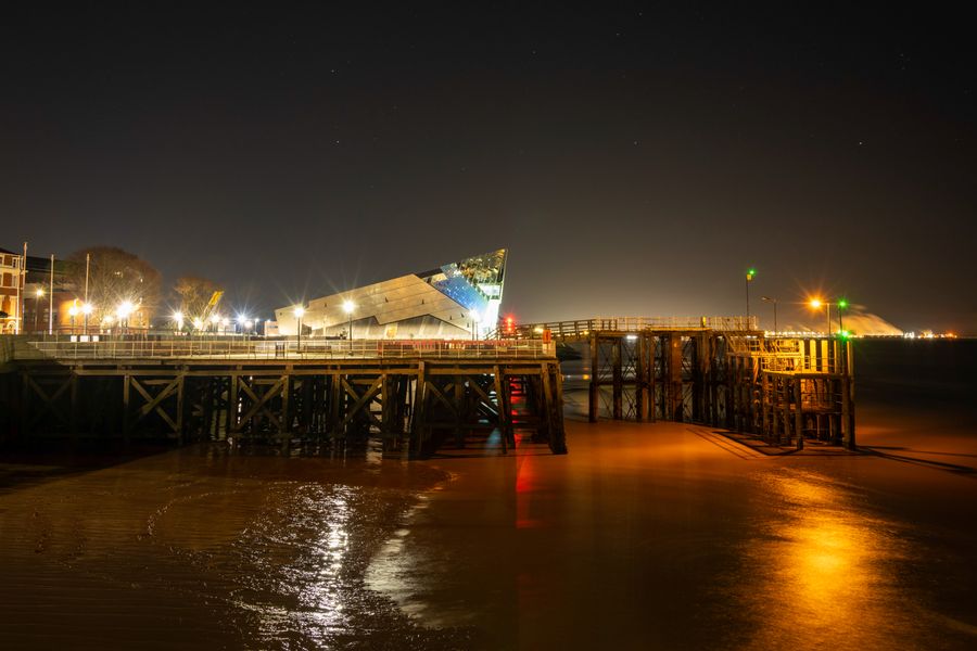 The Deep looking across the former ferry pier at night