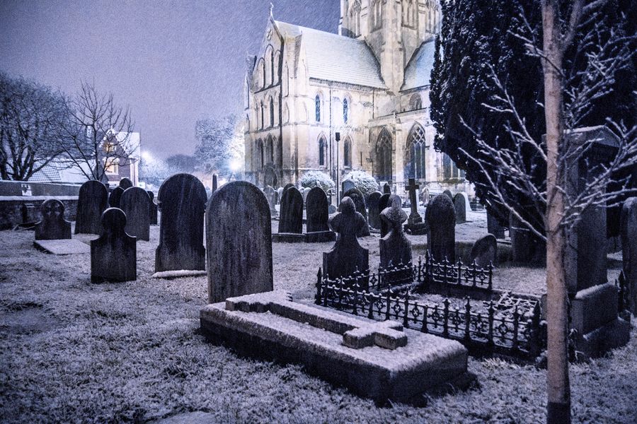 Gothic style church graveyard in the snow.