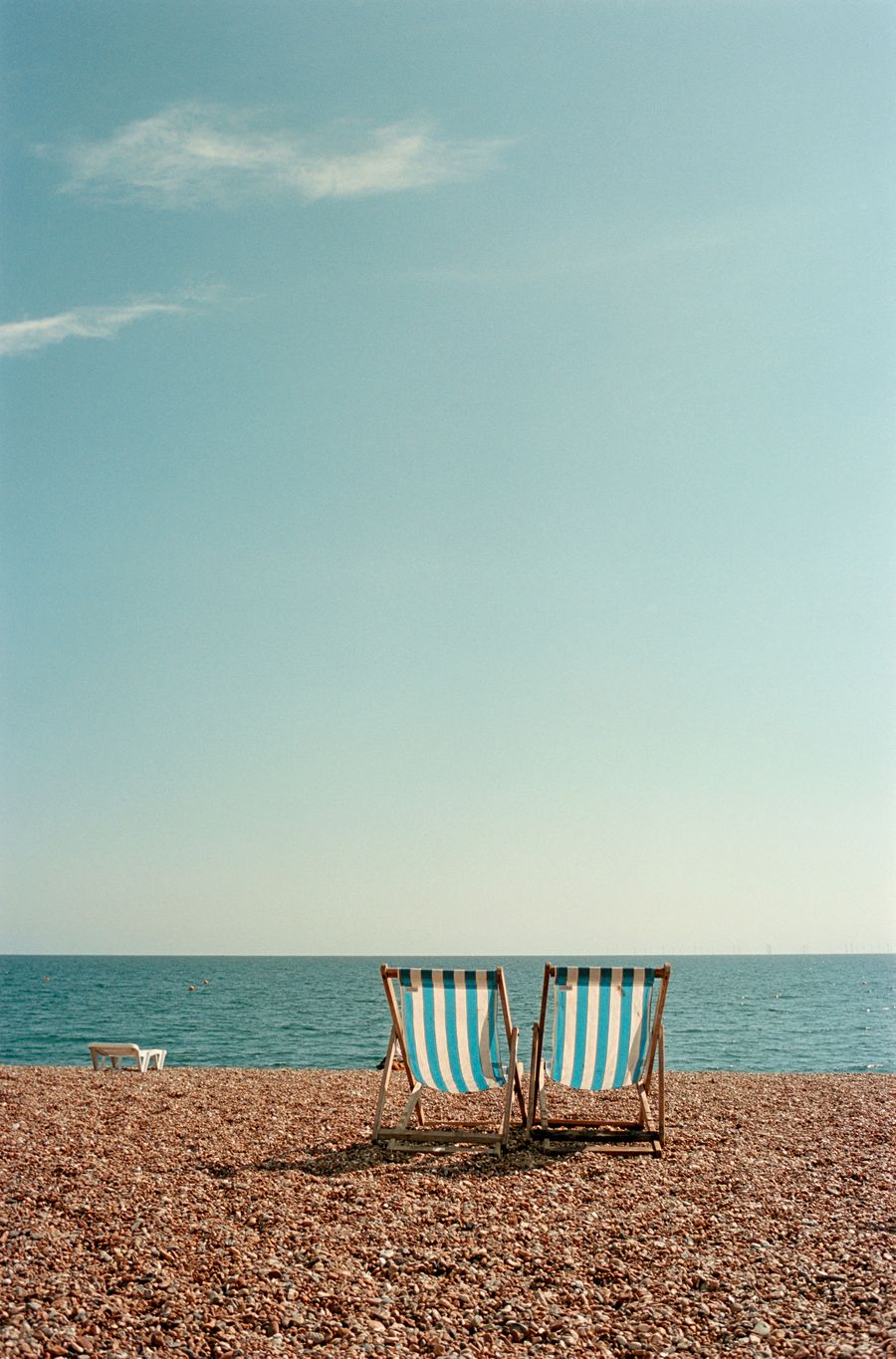 Two deckchairs on the beach