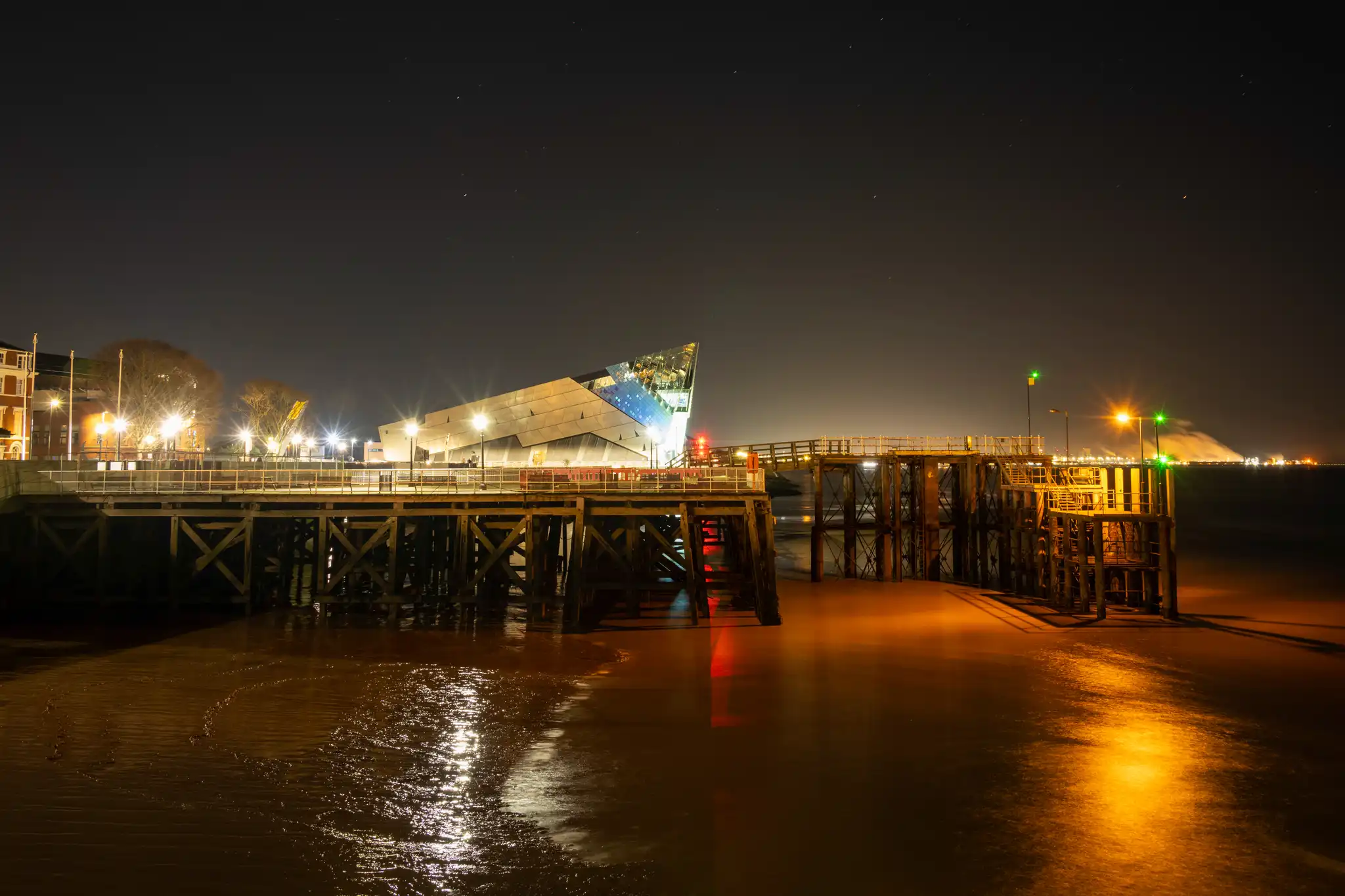 The Deep looking across the former ferry pier at night